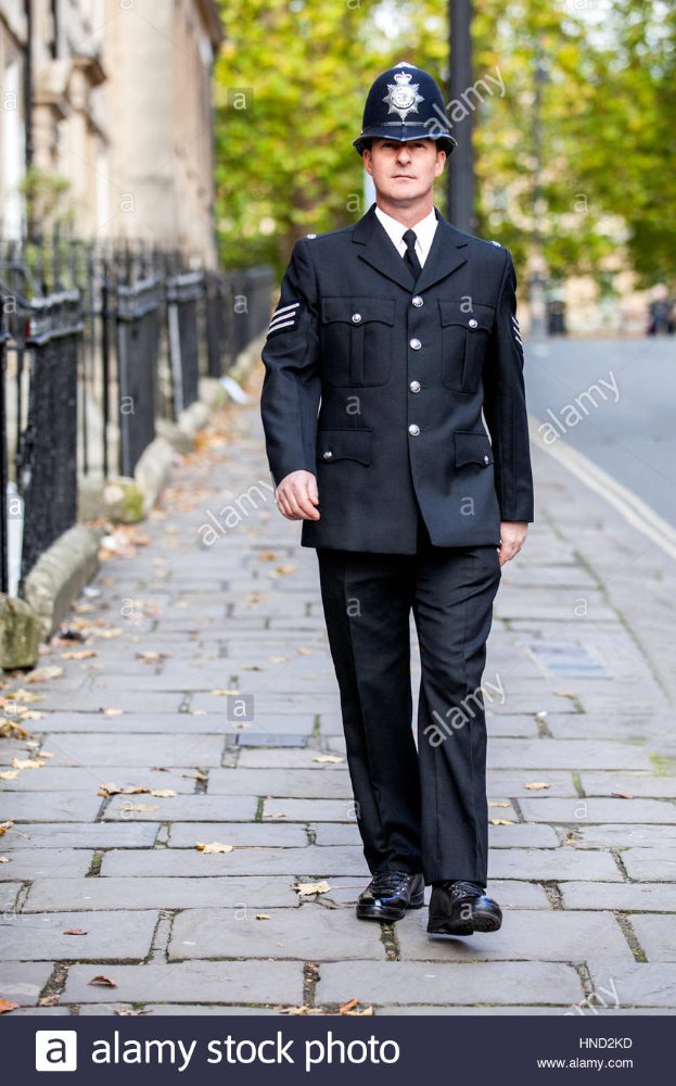 a-smartly-dressed-english-policeman-in-full-uniform-patrolling-his-HND2KD.jpg